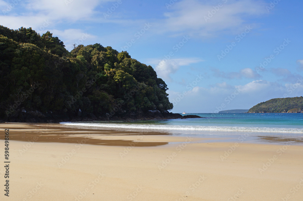 View across the golden sand on Butterfield Beach, Half Moon Bay, Stewart Island, New Zealand