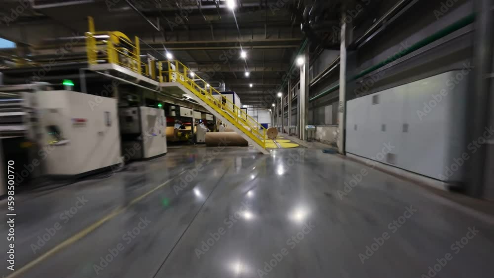Motion past closed production line and large paper rollers in production workshop first point view. Papermaking factory facilities Generative AI Motion past closed production line and large paper rollers in production workshop first point view. Papermaking factory facilities Generative AI
