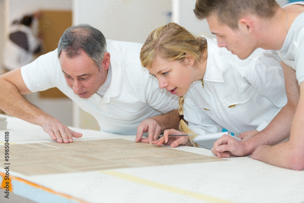 teacher carpenter with woman and man in workshop