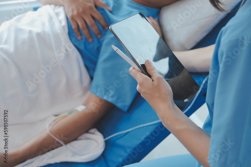 Injured patient showing doctor broken wrist and arm with bandage in hospital office or emergency room. Sprain, stress fracture or repetitive strain injury in hand. Nurse helping customer. First aid.