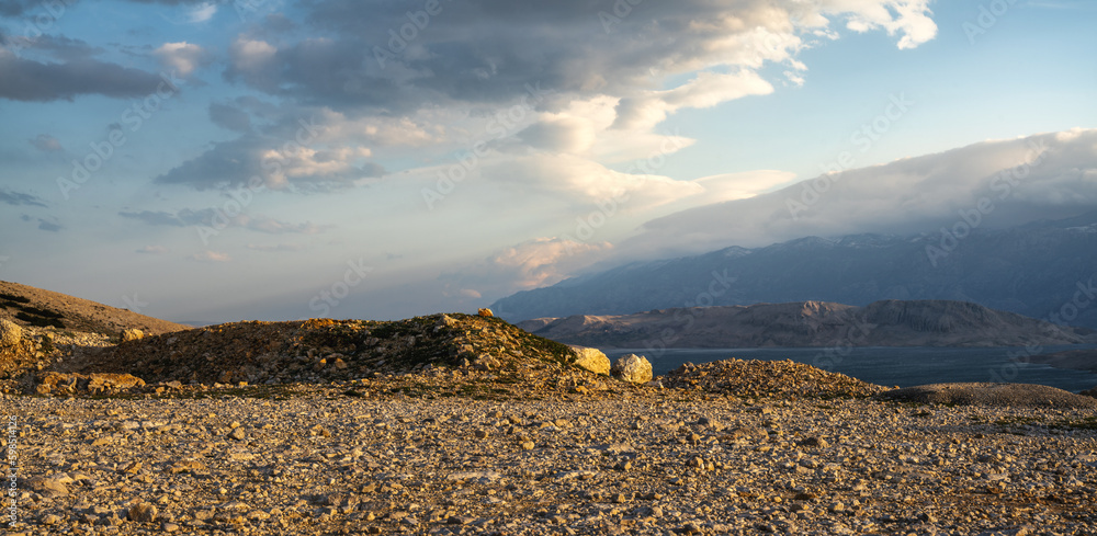 Gravel parking at a viewpoint overlooking mountain peaks