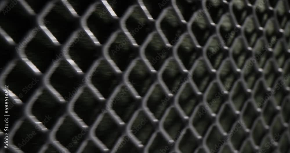 Durable metallic large mesh for building fences quickly moving. Dark square metal grid pattern and texture as seamless design element Durable metallic large mesh for building fences quickly moving. Dark square metal grid pattern and texture as seamless design element