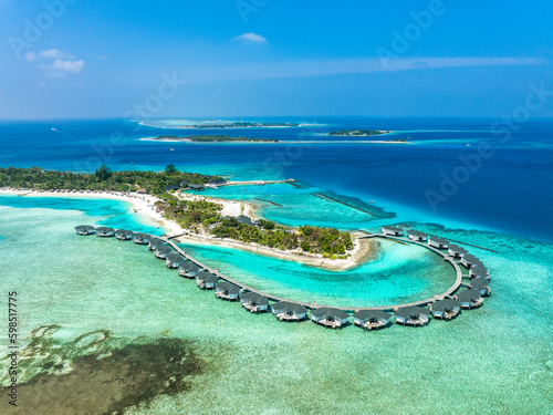 Water bungalows on Kanuhura island resort at Indian Ocean in Maldives photo