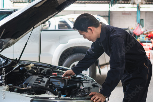 Portrait of a mechanic repairing a car in garage, Auto mechanic working in garage, Maintenance and Repair service.