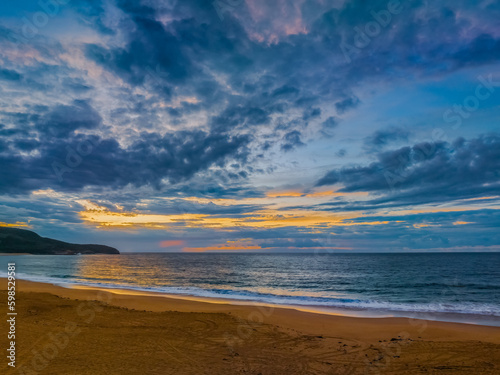 Sunrise seascape with clouds and gentle surf