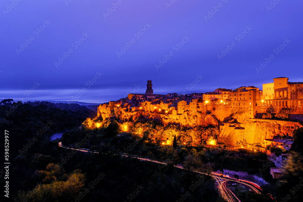 Old historical medieval town of Pitigliano in Tuscany at sunset, Italy