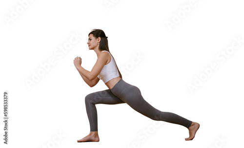 Brunette caucasian young woman in sportswear practicing yoga at home, makes lunges against transparent background. Fit American girl warms up at fitness class before training. Sport and fitness.