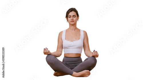 Young brunette caucasian woman in sportswear sitting in meditation on floor eyes closed against transparent background relaxing. Hispanic girl practicing yoga at fitness class. Mental balance concept