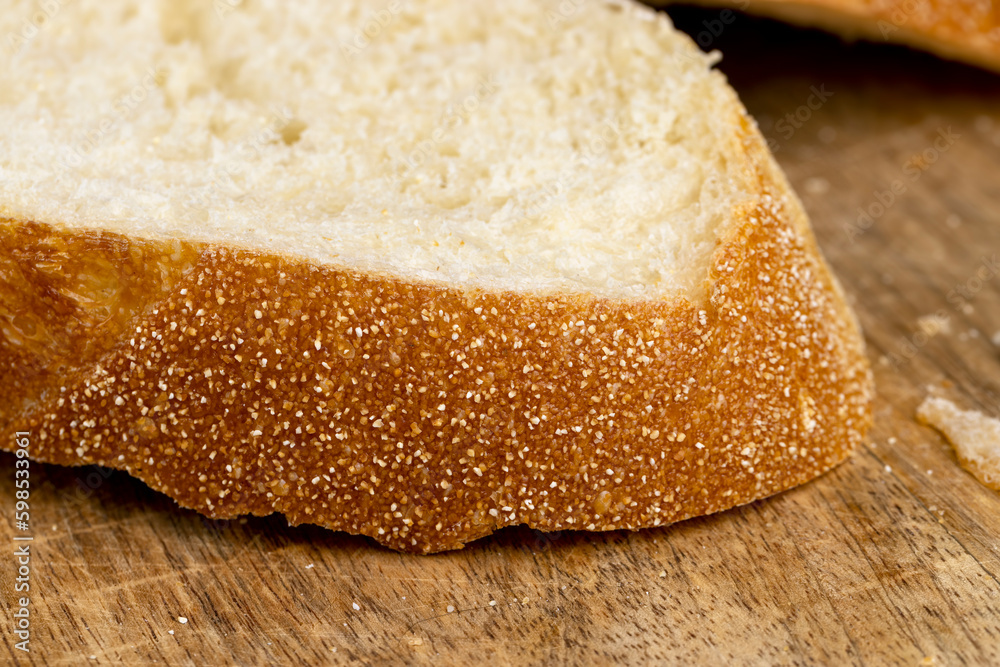 A cut loaf of round-shaped wheat bread