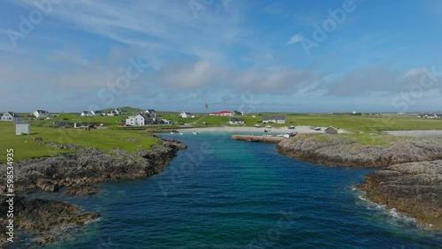 A kitesurfer in a small harbour on the Isle of Tiree, aerial shot. photo