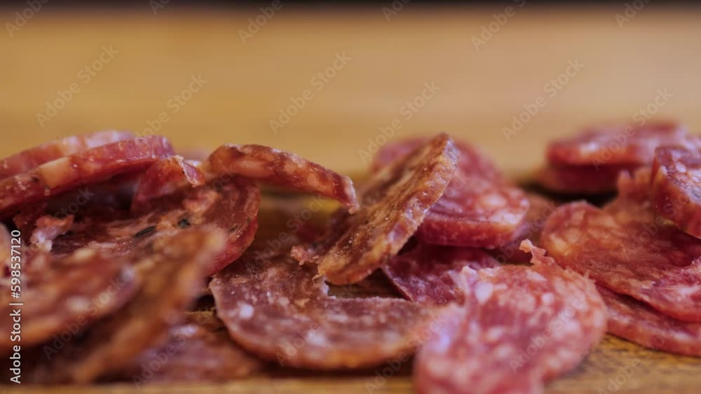 Close up bartender presents a wooden board of sliced salami, perfect beer snack for a group of friends enjoying a warm and inviting atmosphere in a bar or cafe. The aroma of cured meats and drinks. Close up bartender presents a wooden board of sliced salami, perfect beer snack for a group of friends enjoying a warm and inviting atmosphere in a bar or cafe. The aroma of cured meats and drinks.