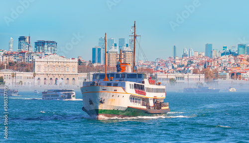 Sea voyage with old ferry (steamboat) on the Bosporus - Dolmabahce palace coastal cityscape with modern buildings under cloudy sky - Istanbul, Turkey 