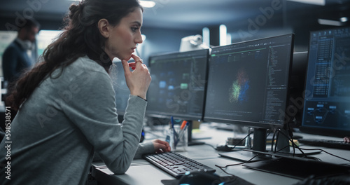 Portrait of a Thoughtful Young Engineer Working on Computer in a Technological Office Environment. Beautiful Multiethnic Woman Writing Software Code for a Blockchain Project