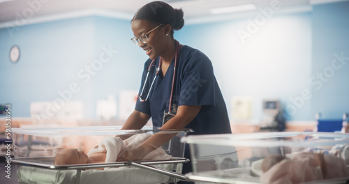 Cute Emotional Newborn Little Infant Lying in Hospital Cot. Young Black Pediatrician Taking Care of the Baby and Fixing the Blanket. Healthcare, Pregnancy and Motherhood Concept photo