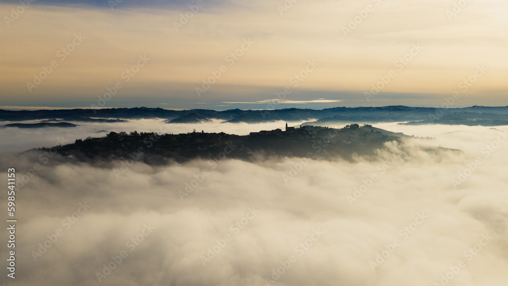 a hill town surrounded by fog, (Diano d'Alba)