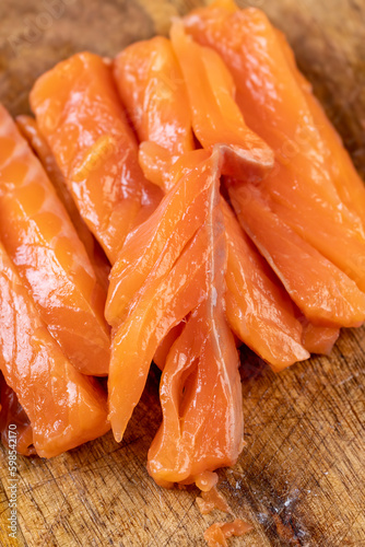 Sliced red trout meat with sea salt