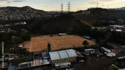 Aerial view of people playing soccer in the Naucalpan slum, sunset in Mexico city photo