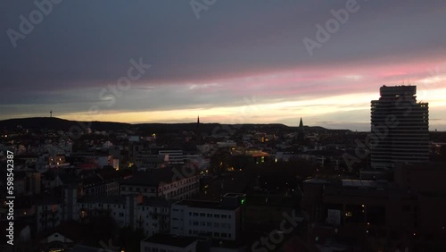 Aerial Establishing night Cityscape shot of Kaiserslautern City center ( K-town ) in west Germany known for the U.S military Community of Ramstein Air force Base settling in the city. photo