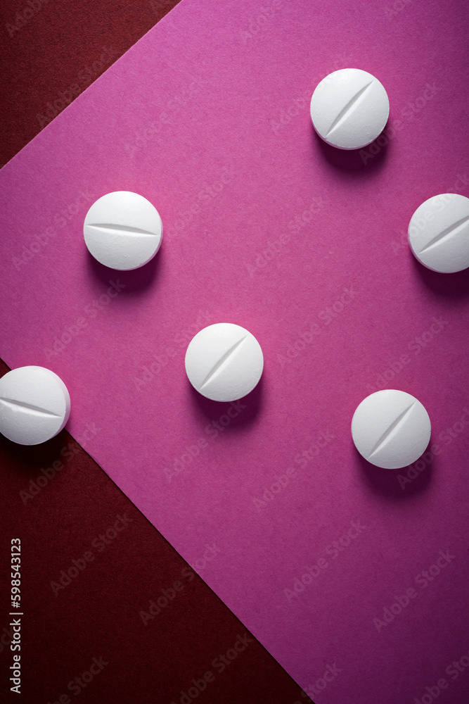 White medicine tablets on a table White medicine tablets on a table