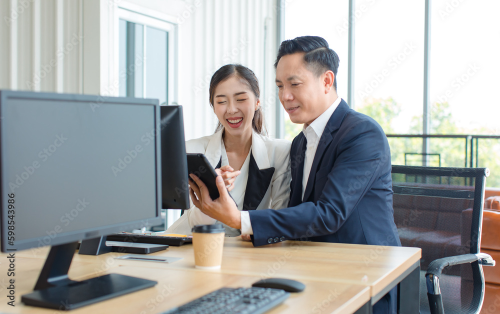 Asian professional successful female businesswoman secretary employee showing information strategy data via computer to male businessman manager in formal business suit in office room Asian professional successful female businesswoman secretary employee showing information strategy data via computer to male businessman manager in formal business suit in office room