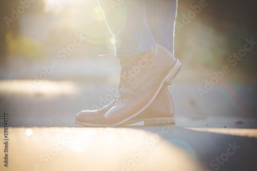 Close up image of a pretty woman with muscular legs wearing handmade leather boots.