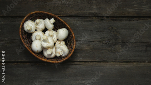 Fresh champignons uncooked on a wooden table