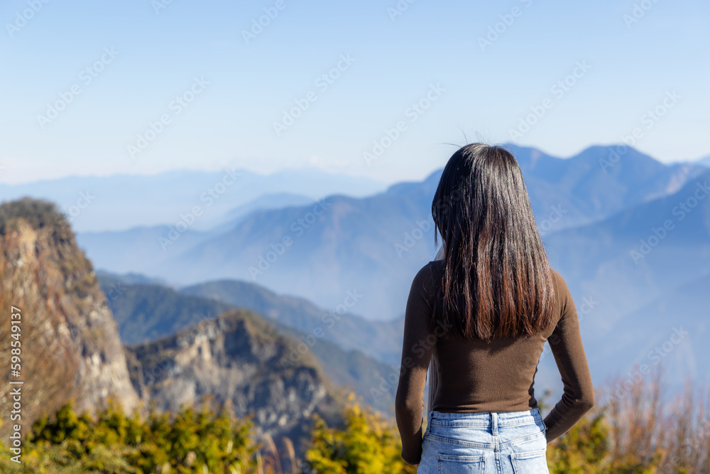 Woman go hiking and enjoy the scenery view on the mountain