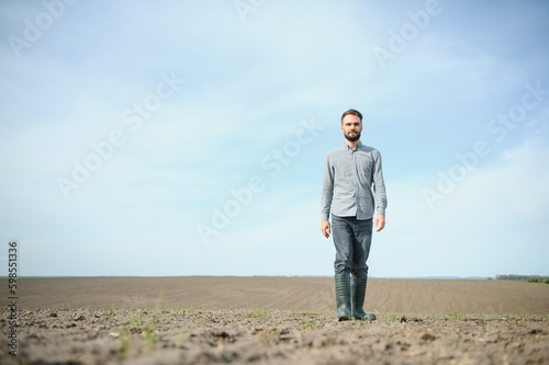 Portrait of farmer standing in field. © Serhii