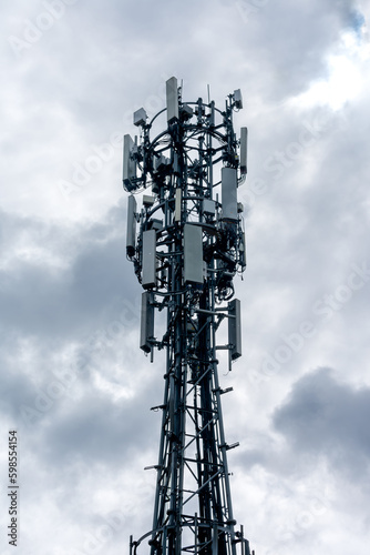 A WiFi tower, antenna with a cloudy sky background.