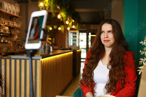 woman makes tik tok in cafe