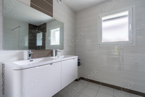 Home bathroom, bright new bathroom interior with tiled glass shower, vanity cabinet, interior designed white and brown