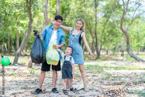 Asian family picking up trash in the forest. Litter cleanup activities. Environment protection. recycling.