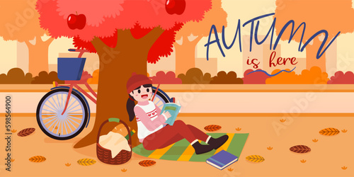 Girl reading book under apple tree in garden