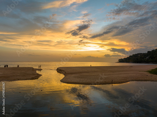 aerial view stunning reflection of bright golden sky in a canal at Karon beach Phuket. Imagine a fantasy colorful clouds changing in sky of sunset. Gradient color. Sky texture   nature background.