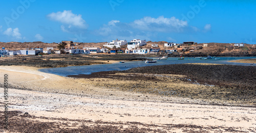 Panoramic view of the village Majanicho full of colourful houses and fishing boats on the touristic Fuerteventura from the beach El Hierro or Playa de las Palomitas on the coast of Canary Islands