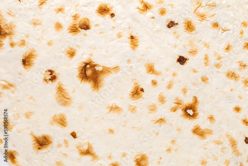 Background, pita bread handmade in tandoor close-up, uniform texture © elenvd
