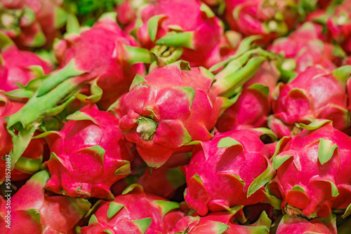 Pitaya  dragon fruit whole  in bulk  on supermarket  selective focus