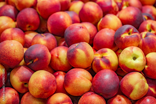 Nectarines, peaches, whole, in bulk, on supermarket, selective focus