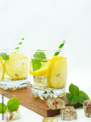 Glass of lemonade with straw isolated on a white background
