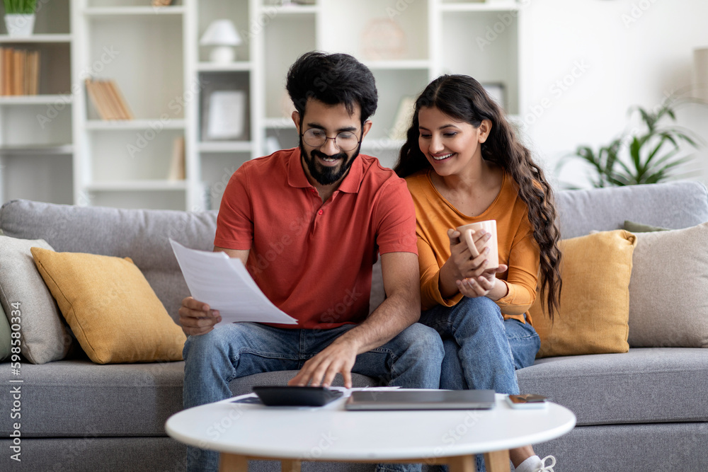Indian Married Couple Planning Budget Together, Reading Papers And Calculating Spends Generative AI - obrazy, fototapety, plakaty 