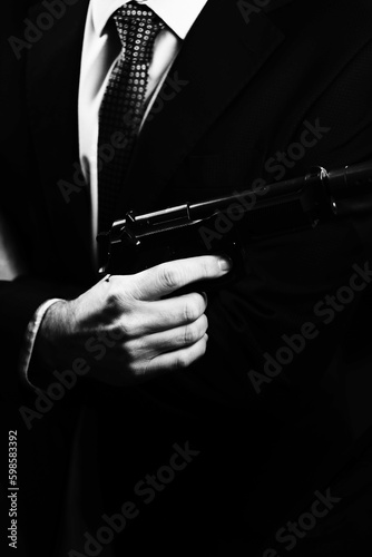 Elegant man holding gun