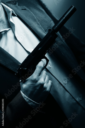 Elegant man holding gun