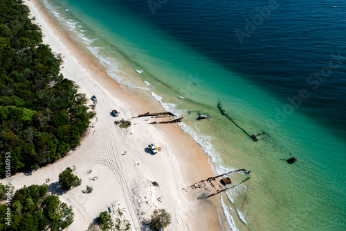 Shipwrecks and offroad vehicles on pristine beach at Moreton Island photo