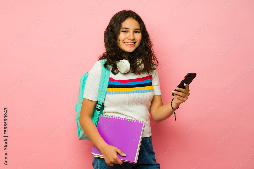 Portrait of a teen girl student texting on the smartphone at school Portrait of a teen girl student texting on the smartphone at school