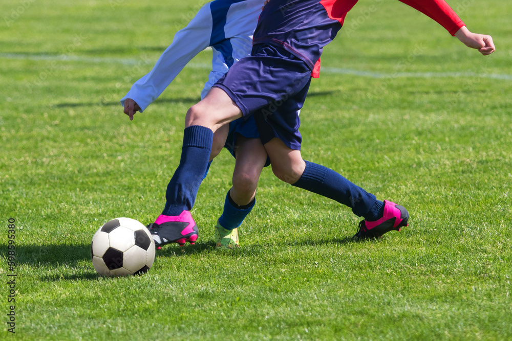 Soccer Players in a Duel on Grass Running After Soccer ball Soccer Players in a Duel on Grass Running After Soccer ball