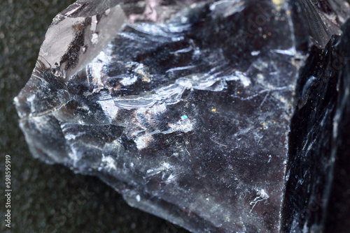 Obsidian rock. Volcanic material. Rough edges. Sharpest rock, close up macro