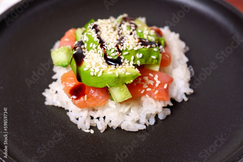 Sushi waffles are crispy rice cooked in a waffle iron, with salmon crunchy cucumber, and avocado.