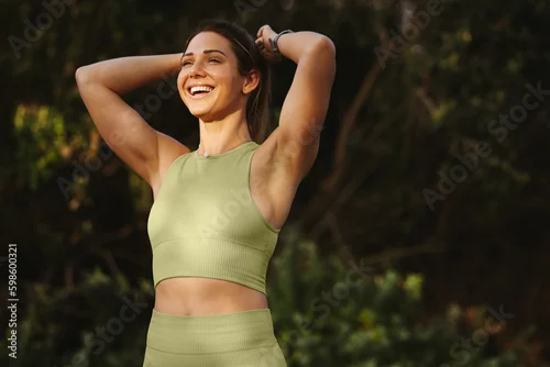 Fototapeta samoprzylepna Woman warming up for a morning workout outdoors