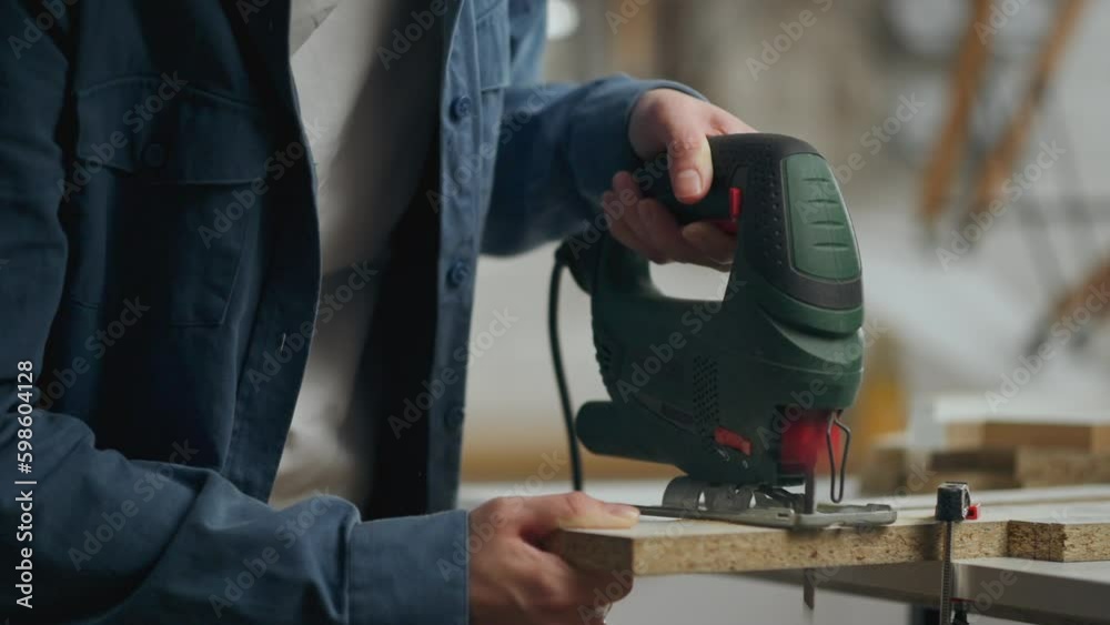 Carpenter, Active caucasian woman Cutting with a power tool with a jigsaw In a new private house, Active young worker assembling new furniture, Standing in front of a work surface, work tool
