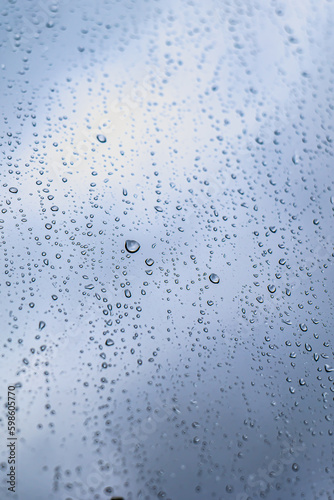 close up of water droplets on clear window. rainy day concept.